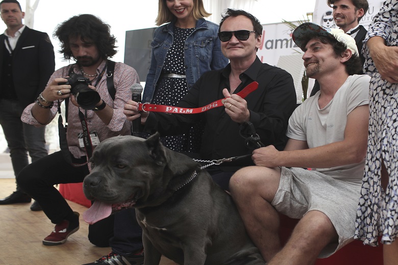 Director Quentin Tarantino poses for photographers with the Palm Dog collar award for the the dog Brandy that appeared in his film 'Once Upon a Time in Hollywood' at the 72nd international film festival, Cannes, southern France, Friday, May 24, 2019. (AP Photo/Petros Giannakouris)